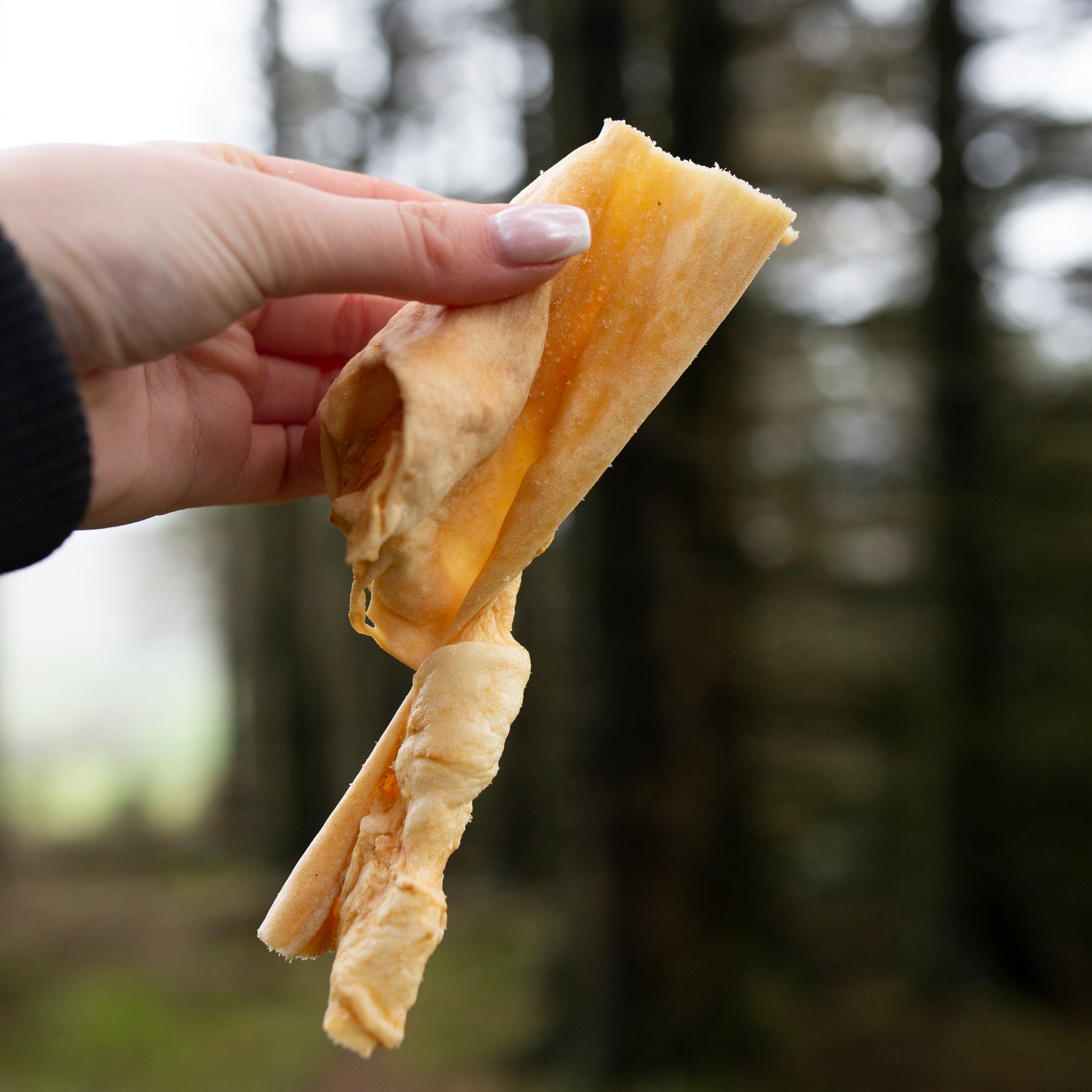 Lamb skin bulk bag from Mabel's Natural Pet Supplies™, showing fresh, natural lamb skin pieces in a 1kg or 500g package.