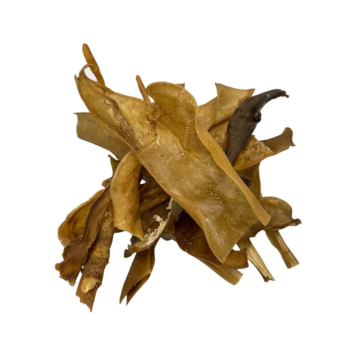Natural goat skin dog treats in a bulk bag by Mabel's Natural Pet Supplies, showing raw, dried goat skin treats for dogs.