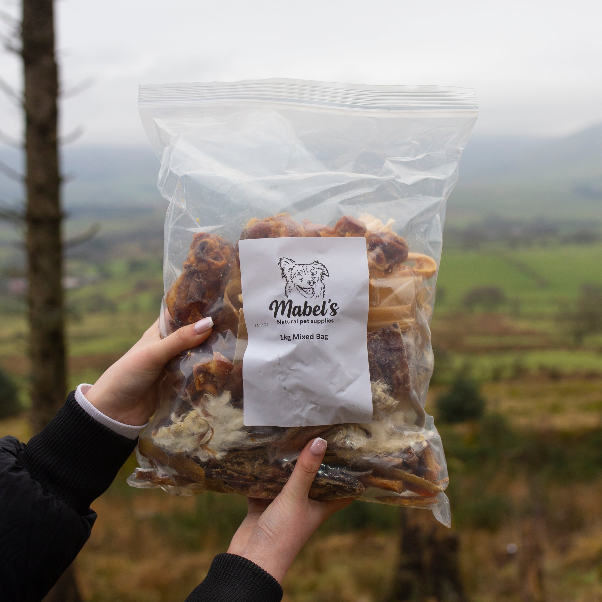 Mabel's Natural Pet Supplies™ dog treats including hairy rabbit ears, pork crunch, beef trachea, beef skins, and paddy wack in a 1kg bulk bag