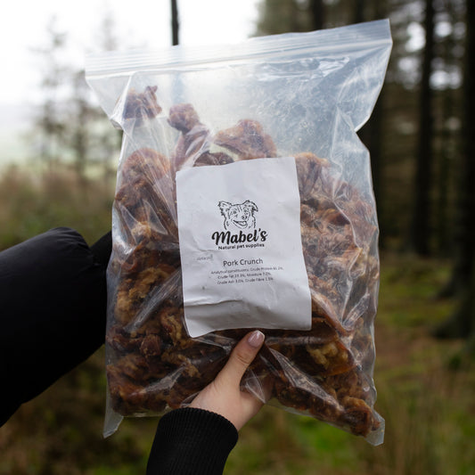 Mabel's Natural Pet Supplies pork crunch dog treats in a 1kg bulk bag, showing crunchy pork treat pieces for dogs.